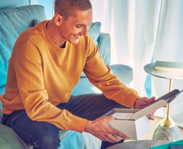 Young man opens his IQOS gift box